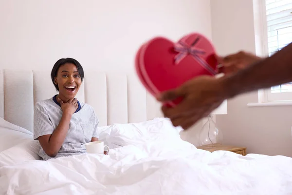 Loving Man Surprising Woman Romantic Box Chocolates Bedroom — Stock Photo, Image