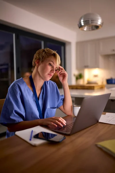 Tired Woman Wearing Medical Scrubs Working Studying Laptop Home Night — Stock Photo, Image