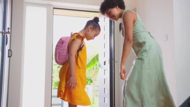 Mother Helping Daughter Put Backpack Leave House Front Door School — Stock Video