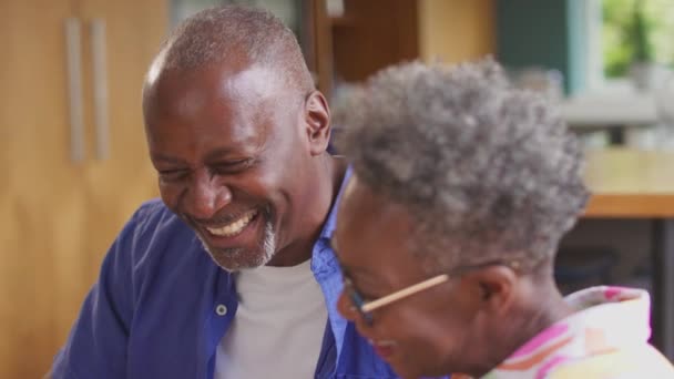 Uśmiechnięta Para Seniorów Siedząca Przy Stole Domu Przeglądająca Finanse Krajowe — Wideo stockowe