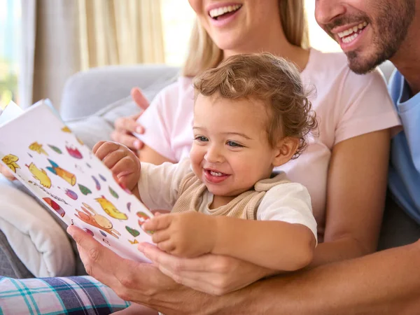 Family Sitting Sofa Home Parents Reading Book Young Son — Stock Photo, Image