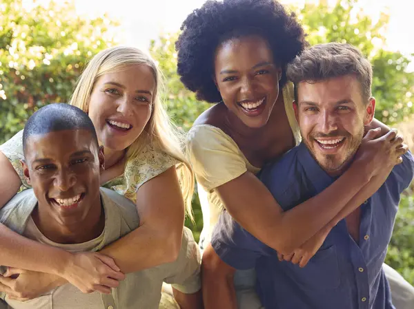 stock image Portrait Of Multi-Cultural Friends On Holiday With Men Giving Women Piggybacks