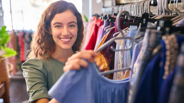 Portrait Of Female Owner Or Worker In Fashion Clothing Store Checking Stock With Digital Tablet