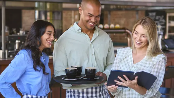 Multi-Cultural Staff Team With Digital Tablet Working In Restaurant Or Coffee Shop