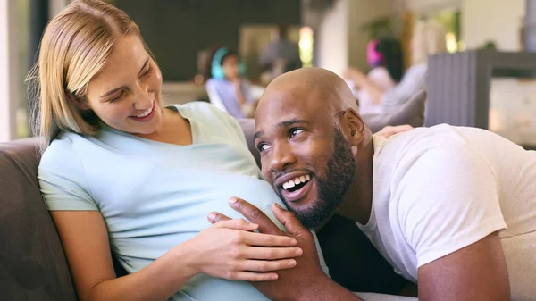 Couple Man Listening Pregnant Woman Stomach Sofa Home Multi Generation — Stock Photo, Image