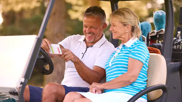 Senior Couple Sitting Buggy Golf Course Marking Score Card Together — Stock Photo, Image