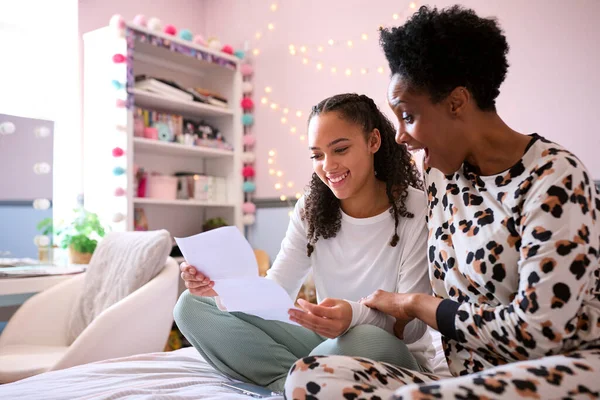Mother Teenage Daughter Bedroom Looking Letter Positive Exam Results Together — Stock Photo, Image