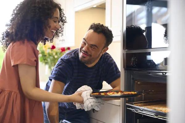 Couple Home Man Syndrome Woman Taking Pizza Out Oven Kitchen — Stock Photo, Image