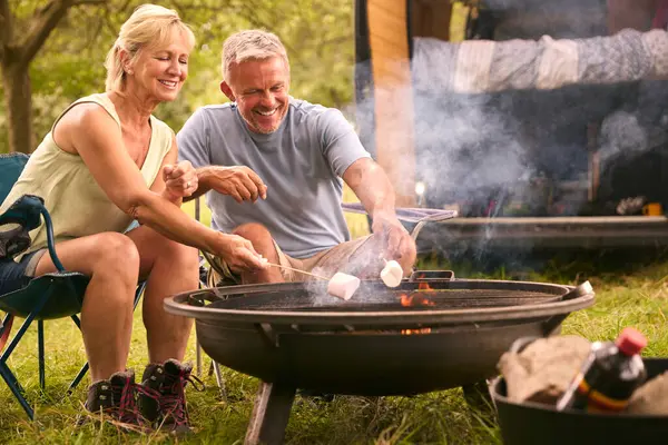 Senior Couple Camping Countryside Toasting Marshmallows Outdoors Fire — Stock Photo, Image