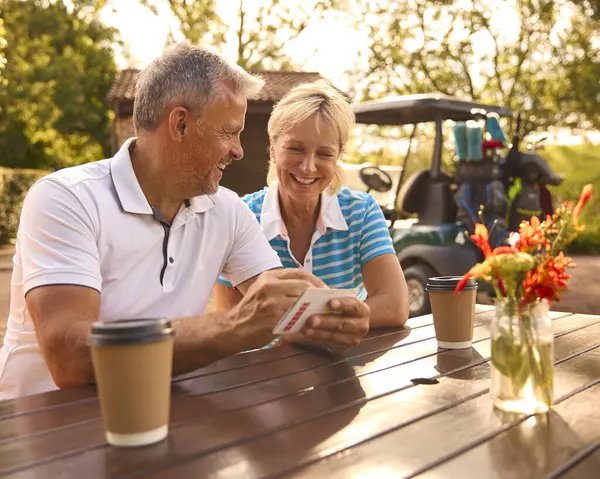 Senior Couple Sitting Having Coffee Golf Looking Score Card Together — Stock Photo, Image