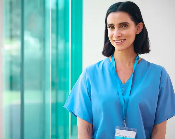 Portrait Mature Smiling Female Doctor Wearing Scrubs Hospital — Stock Photo, Image