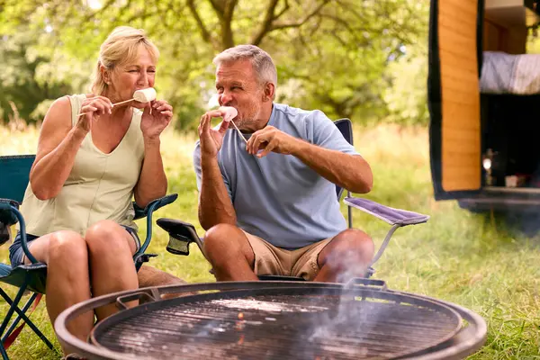 Senior Couple Camping Countryside Toasting Eating Marshmallows Outdoors Fire — Stock Photo, Image