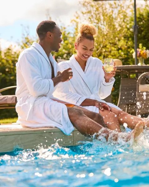Loving Couple Wearing Robes Outdoors Sitting Drinks Splashing Feet Swimming — Stock Photo, Image