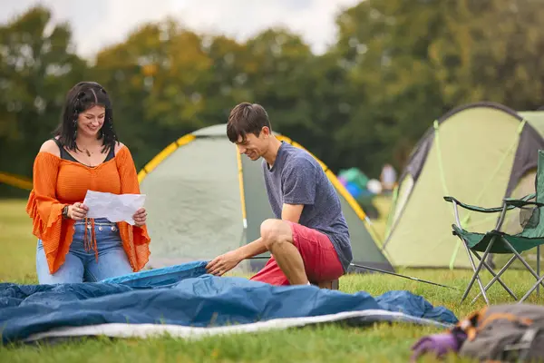 Young Couple Reading Instructions Putting Tent Summer Music Festival Unpacking Stock Image