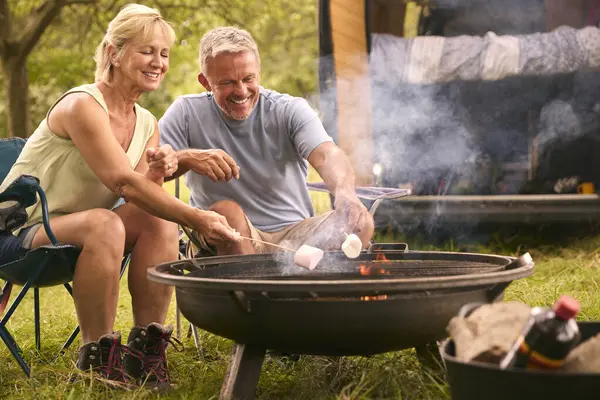 Senior Couple Camping Countryside Toasting Marshmallows Outdoors Fire — Stock Photo, Image