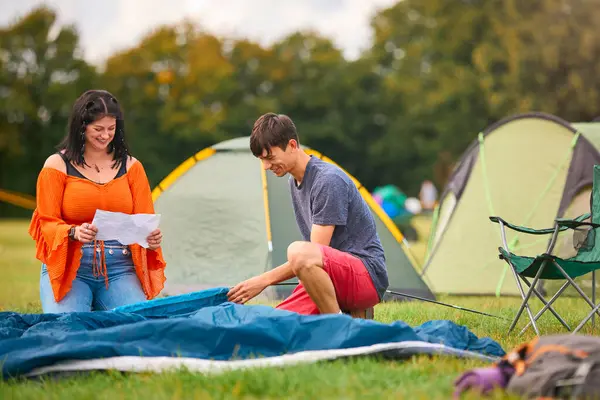 Young Couple Reading Instructions Putting Tent Summer Music Festival Unpacking Royalty Free Stock Images