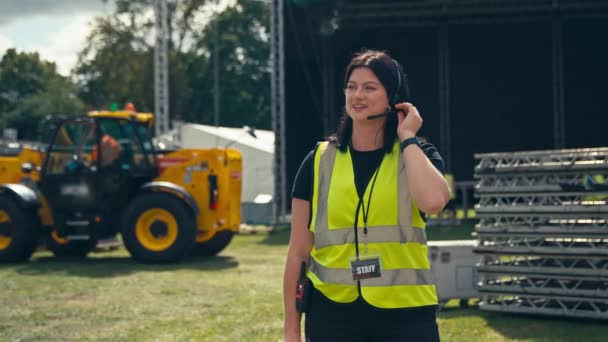 Female Production Worker Talking Radio Headset Setting Stage Music Festival — Vídeos de Stock