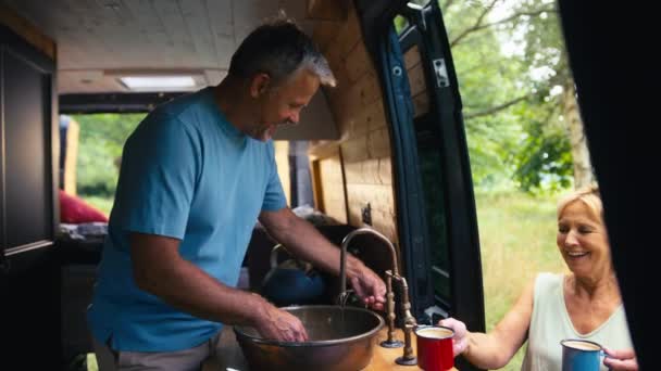 Senior Couple Enjoying Camping Countryside Relaxing Man Washing Woman Bringing — Stock Video