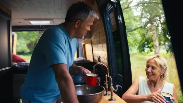 Senior Couple Enjoying Camping Countryside Relaxing Man Washing Woman Drinking — Stock Video