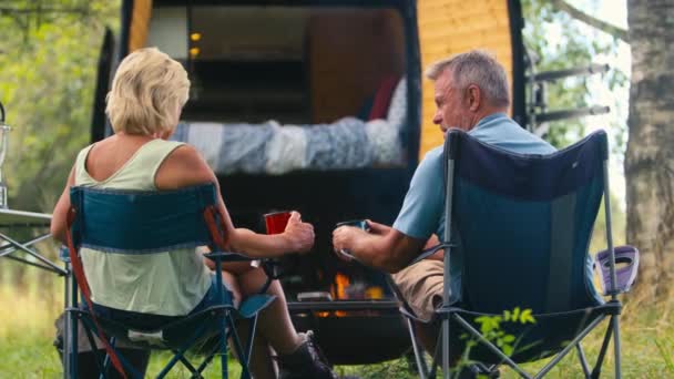 Rear View Senior Couple Camping Countryside Drinking Coffee Outdoor Fire — Stock Video