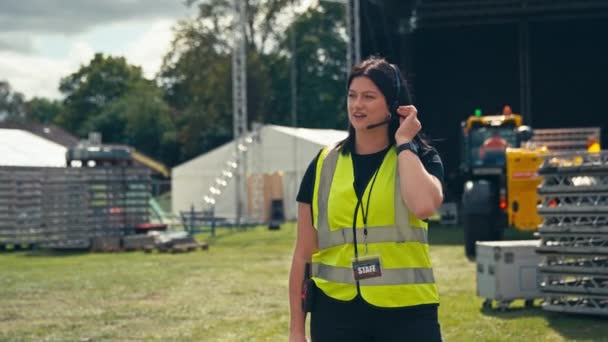Female Production Worker Talking Radio Headset Setting Stage Music Festival — Vídeos de Stock