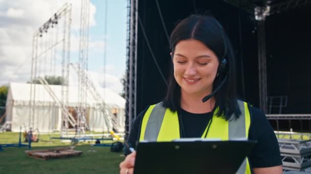 Female Production Worker Radio Headset Setting Outdoor Stage Music Festival — Vídeos de Stock