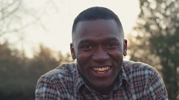 Close Portrait Smiling Man Outdoors Autumn Countryside Flaring Sun Shot — Stock Video