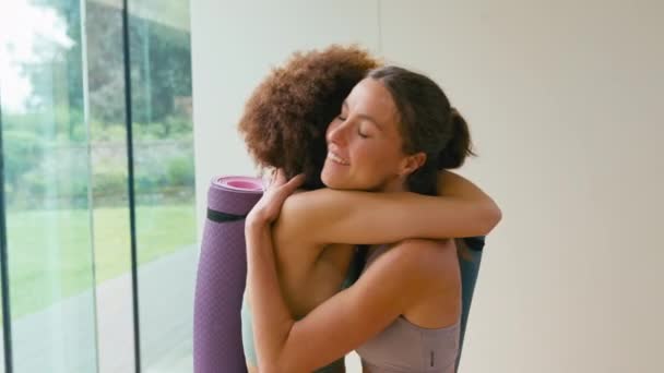 Two Female Friends Meeting Hugging Gym Yoga Studio Exercise Shot — Stock Video