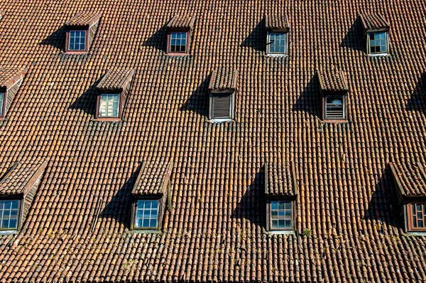 Massive Tiled Roof Straight View Row Protruding Windows Different Levels — Stock Photo, Image