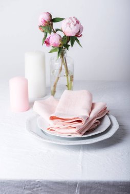 Beyaz renkli keten masa örtüsü ve şakayık, seçici odak resmi olan zarif bir masa.