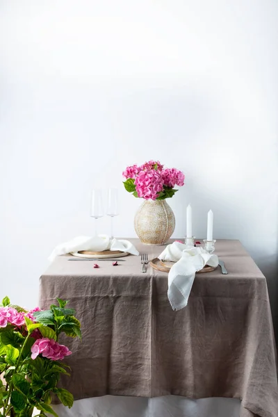 stock image Elegant table with linen tablecloth in white color and hydrangea, selective focus image