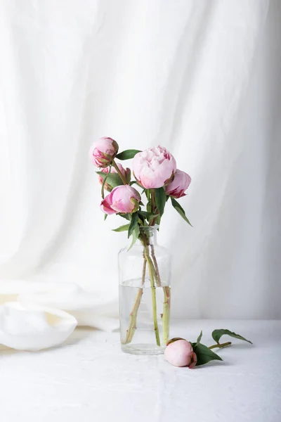 白と牡丹のリネンのテーブルクロスを持つエレガントなテーブル 選択的な焦点画像 — ストック写真