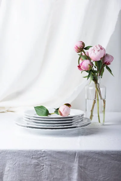 stock image Elegant table with linen tablecloth in white color and peony, selective focus image