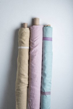 Pembe, yeşil ve açık renkli doğal keten kumaş ruloları