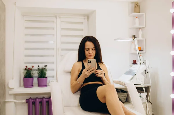 A young woman is waiting for laser hair removal in a beauty salon