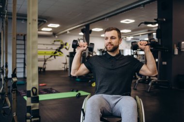 Hardworking person with a disability exercising with weights in the gym