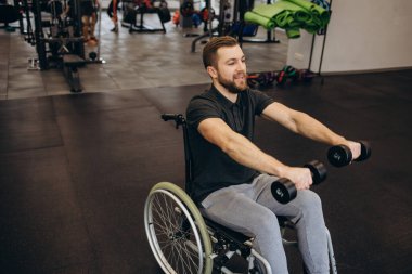 Person who uses a wheelchair training in the gym. Rehabilitation center