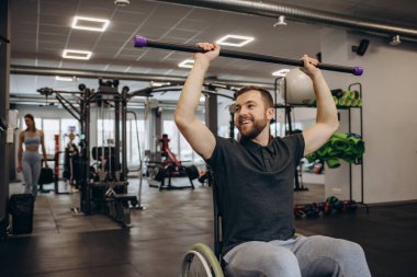 Hardworking person with a disability exercising with weights in the gym