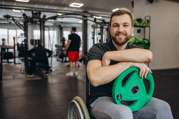 Hardworking person with a disability exercising with weights in the gym