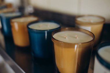 Natural eco home decor with dry boho sticks and candle on wooden table. Poster for handmade candle master class. Mock up for candle production. Space for text. Background for spa salon