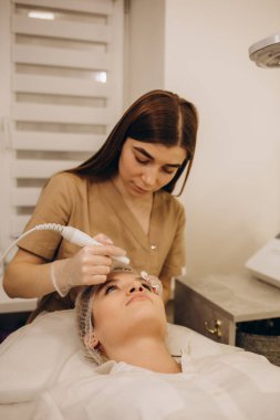 Beautiful woman receiving ultrasound cavitation facial peeling. Cosmetology and facial skin care. facial treatment, face cleansing
