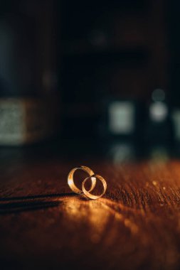 wedding rings on a table on a dark background