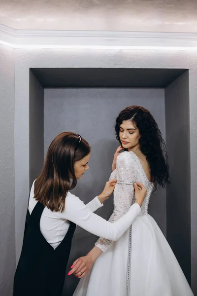 Caucasian female costume designer works on wedding gown - Stock Image -  Everypixel