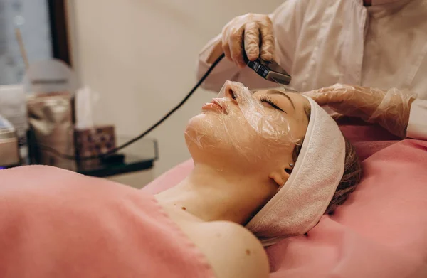 ultrasonic face cleaning, peeling, in a beauty salon.