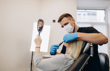 an older woman at an appointment with a plastic surgeon. skin rejuvenation concept