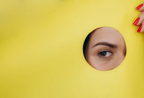 Surprise Portrait Young Caucasian Woman Looking Hole Yellow Paper Distrustful — Stock Photo, Image