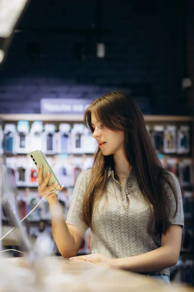 stock image Woman choosing phone at technology store.