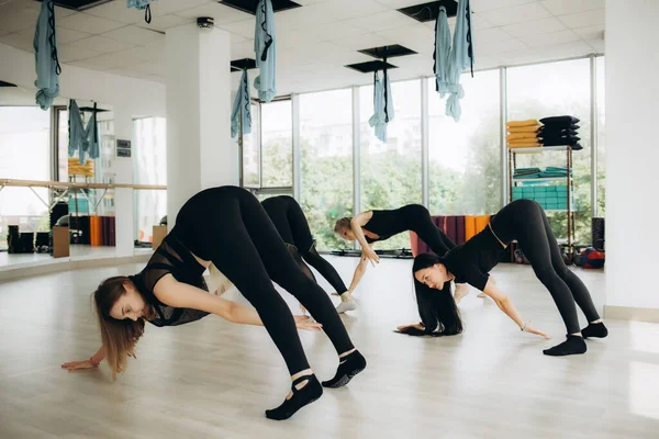 Women exercising in fitness studio yoga classes. High quality photo
