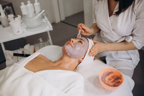 Woman in mask on face in spa beauty salon. High quality photo