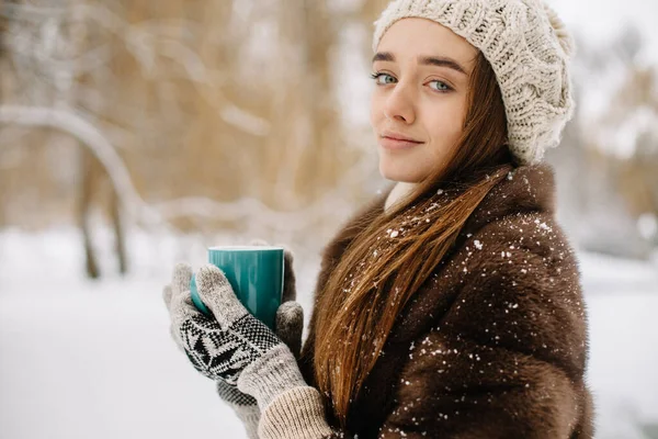 girl drinking hot coffee in winter